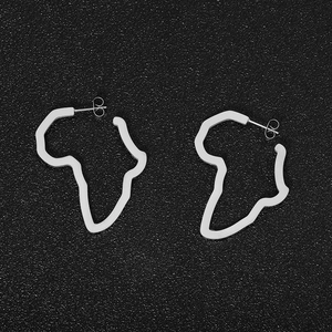 Detailed view of silver Africa map silhouette earrings on black textured surface