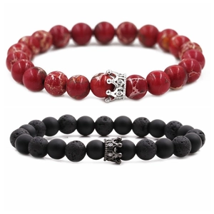 Close-up of 8mm lava stone and red turquoise beaded bracelets with alloy crown charms