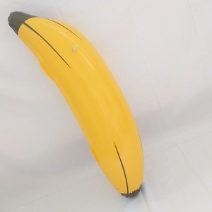 Detail of yellow inflatable banana toy with realistic brown lines on white fabric