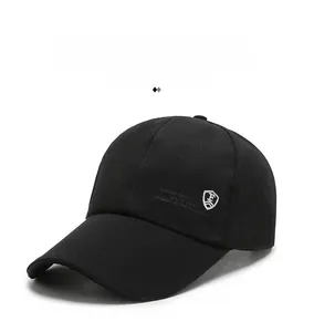 Detailed side view of black baseball cap featuring white sports logo on cotton twill fabric