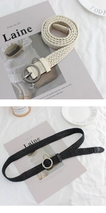 Detail of woven wax rope belts in beige and black with round silver buckles