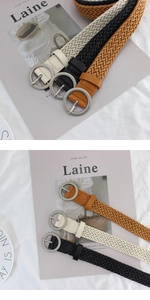 Detailed view of woven belts in beige black and camel with matte silver round buckles