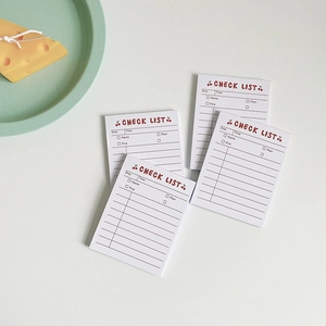Flat lay view of cute cherry stripe check list memo pads on a minimalist white desk