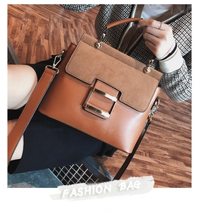 Close-up of caramel brown crossbody bag with metallic square magnetic buckle and top handle