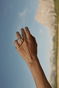 Irregular 925 sterling silver golden open ring shown against a scenic blue sky backdrop