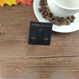 Detail of matte black earring cards with silver FASHION EARRINGS text and various hole styles
