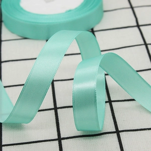 1.5cm wide mint green satin ribbon roll for gift wrapping and wedding decorations