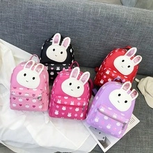 Group display of five colorful children bunny backpacks with sequins and heart patterns