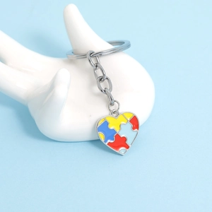 Macro shot of a colorful enamel heart puzzle keychain for autism awareness support