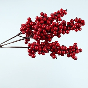 Close-up of vibrant red artificial berry branches for Christmas and DIY floral arrangements