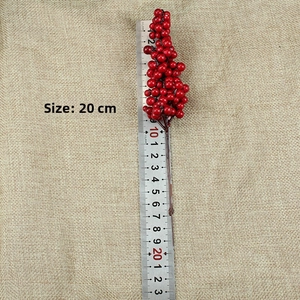 Detail showing 20cm artificial red berry branch with brown stem for Christmas DIY decor