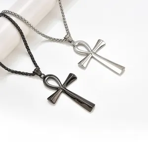 Macro detail of silver and black Ankh cross pendants on stainless steel chains