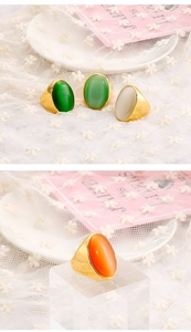 Detailed macro view of four vintage oval cat-eye stone rings with wide gold plating
