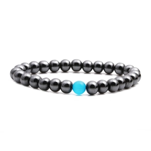 Handmade hematite beaded bracelet with a central blue cat-eye stone on white background