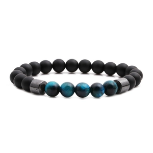 Tiger eye and matte black beaded bracelet with metal spacers on white background