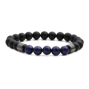 Detail of matte black onyx and blue tiger eye beaded bracelet with metal spacers