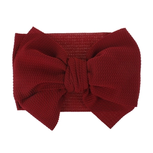 Detailed view of the dark red textured fabric baby bow headband for children.