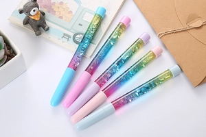 Detailed view of five colorful liquid glitter pens with macaron-style caps and barrels