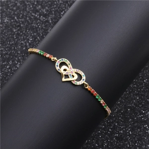 Gold infinity heart bracelet with colorful zircons on a professional jewelry display stand