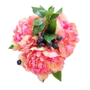 Pink and orange peony silk flower bouquet with green leaves and blue berries on white background