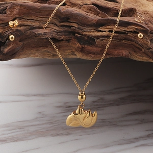 Elegant gold-tone stainless steel jewelry set with leaf pendant necklace and stud earrings