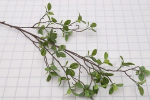 Detailed close-up of artificial Milan leaves with green foliage and brown stems for decor