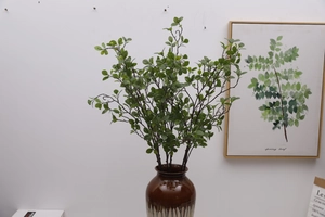 Close-up of artificial Milan leaves in a ceramic vase for realistic indoor decoration