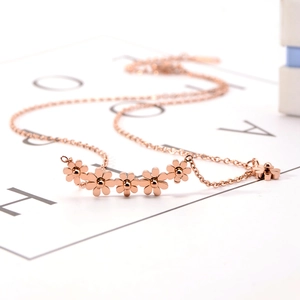 Detailed close-up of rose gold daisy pendant necklace with delicate flower petals