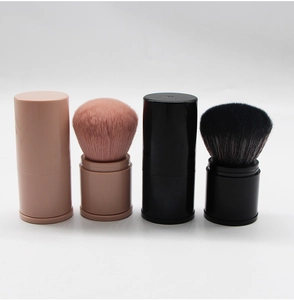 Detail showing pink and black retractable makeup brushes in both closed and open states