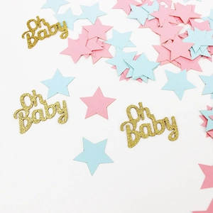 Flat lay of pink and blue star confetti with gold glitter Oh Baby lettering for baby shower
