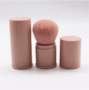 Detail of pink retractable makeup brush showing its open, closed, and capped states