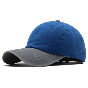 Detail of blue and grey baseball cap featuring reinforced stitching and adjustable strap
