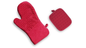 Detail of red silicone oven mitt and pot holder with non-slip texture and hanging loops