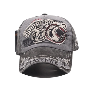 Detail of heavy 3D shark embroidery and vintage washed grey cotton on baseball cap