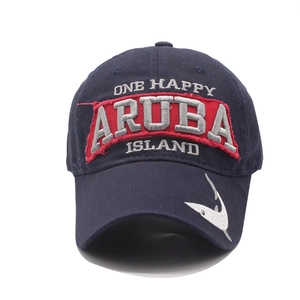 Detail of ARUBA letter embroidery and shark motif on navy blue cotton baseball cap