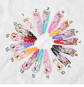Detailed collection of seventeen colorful pet-themed hair clips with cat and dog patterns