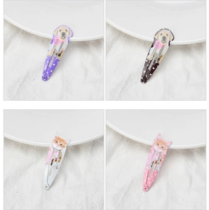 Macro detail of cat and dog print metal BB hair clips in purple, black, white, and pink