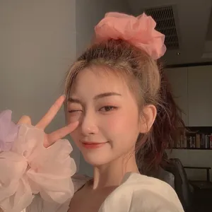 Oversize organza scrunchies in pastel pink and purple for elegant hair styling