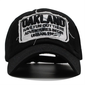 Retro black cotton baseball cap with Oakland embroidered patch and distressed finish