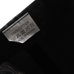 Detail shot of the 100% cotton wash label and interior stitching on this baseball cap