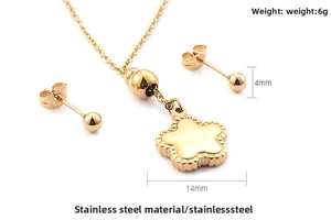Detailed view of gold starfish pendant necklace and ball stud earrings in stainless steel