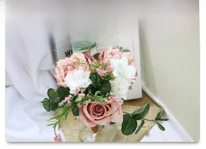 Macro detail of bridal simulation bouquet with pink roses and white accent flowers