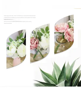 Detail of pink and white faux peonies in ceramic vases for vintage home decoration