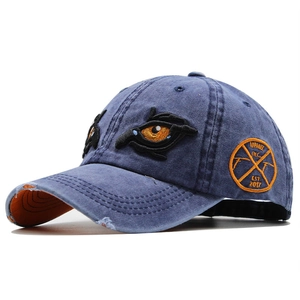 Vintage washed blue denim baseball cap with eye embroidery and distressed brim details