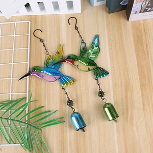 Detailed view of hummingbird metal wind chimes with colorful stained glass and hanging bells