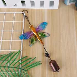 Detailed view of hummingbird wind chime with colorful glass wings and bronze bell