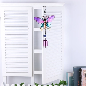 Detail of metal butterfly wind chime with purple blue gradient wings and bronze body