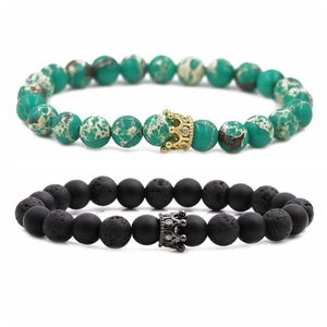 Detailed macro of 8mm lava rock and turquoise bead bracelets with cz crown charms