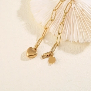 Minimalist gold heart pendant bracelet with textured rectangular links and lobster clasp