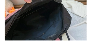Detailed view of the 2D 3D cartoon backpack interior with a zipper pocket and black lining